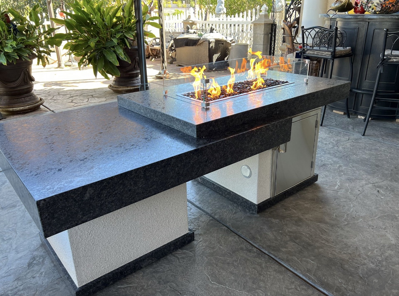 Custom granite fire feature built into an outdoor island
