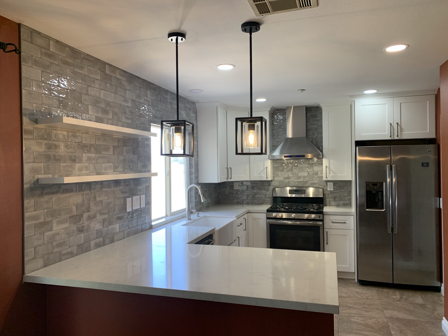Bright kitchen with custom white countertops and full backsplash